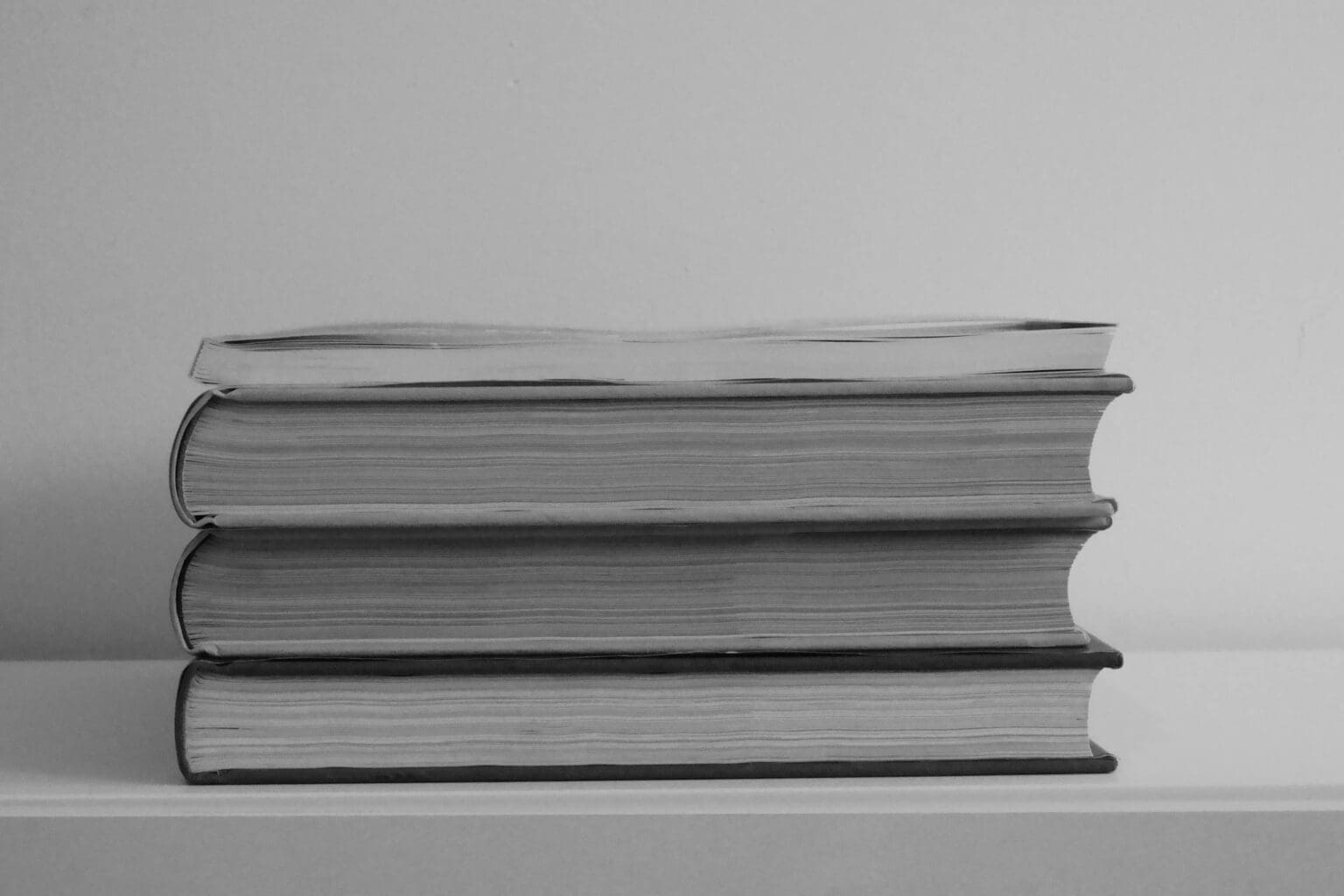 Current image: Stack of Books on White Table